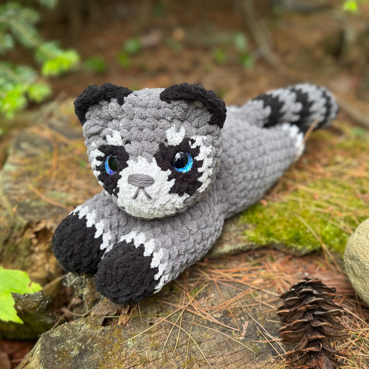 Laying Down Raccoon Crochet Plushie | Hand Painted Eye